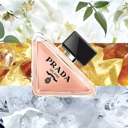 Prada Paradoxe Eau De Parfum For Women 90ml bottle on a decorative background of floral and amber elements.