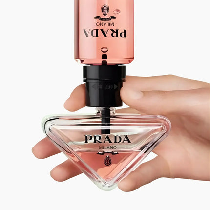 Prada Paradoxe Eau De Parfum For Women 90ml bottle held by hand, showcasing its elegant design.